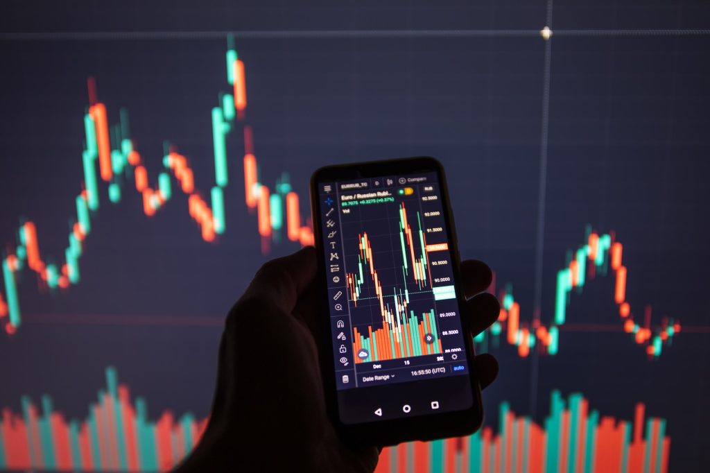 Businessman using a mobile device to check market data