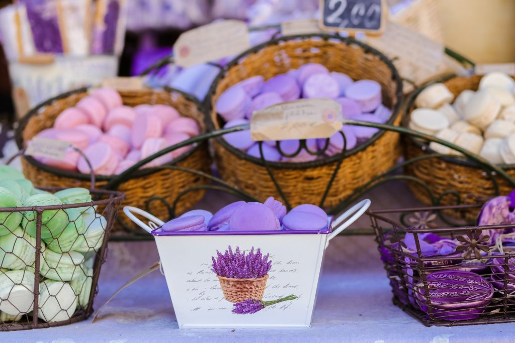 Purple, pink and green herbal aromatic handmade soap at Provençal local market. Small business