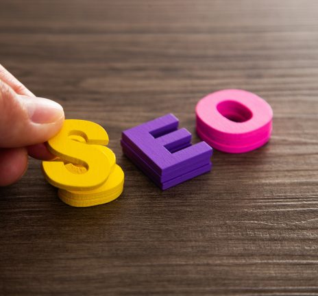 Hand arrange wood letters as SEO abbreviation